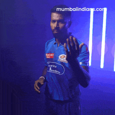 a man in a blue shirt that says mumbai indians