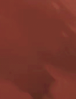 a silhouette of a man standing in front of a red wall .