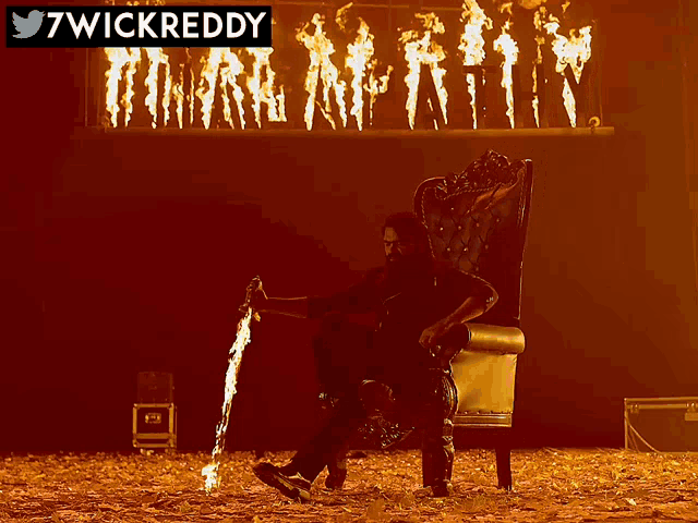 a man is sitting in a chair holding a sword with the words 7wickreddy above him