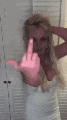 a woman is giving the middle finger with her hand .