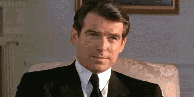 a man in a suit and tie is sitting in a chair in a room .