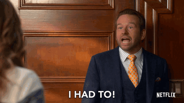 a man in a suit and tie says i had to in front of a netflix logo