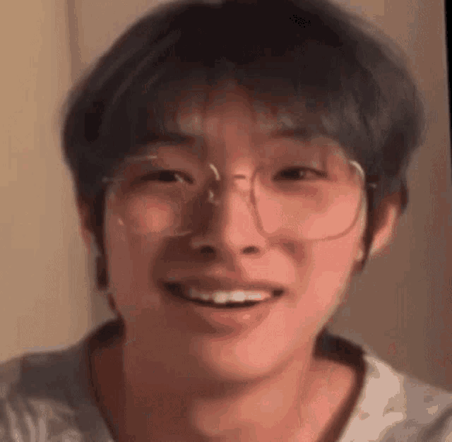 a close up of a man wearing glasses and smiling .