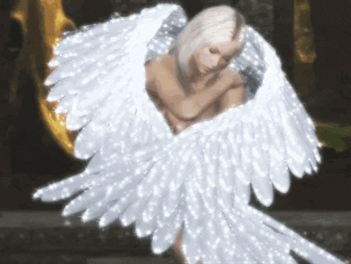 a naked woman with white angel wings is standing in front of a gold statue .