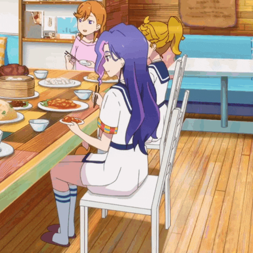 a girl with purple hair is sitting at a table eating food