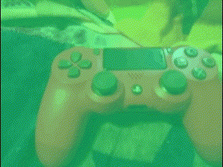 a close up of a video game controller with green buttons