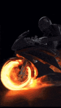 a person is riding a motorcycle with a wheel that is on fire