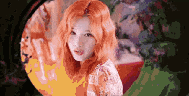 a pixelated image of a woman with red hair looking at the camera
