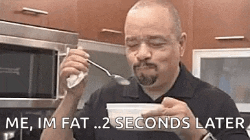 a man is eating yogurt from a bowl with a spoon in his mouth .
