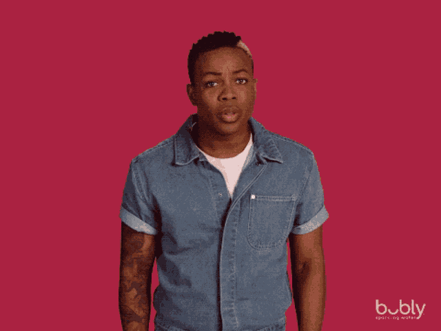 a man with a surprised look on his face is standing in front of a red background that says " no "
