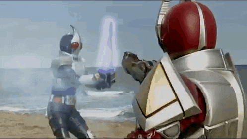 two kamen riders are fighting on the beach with a lightning bolt coming out of their hands .