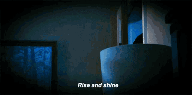 a man is holding a cup of coffee and the words rise and shine are above him