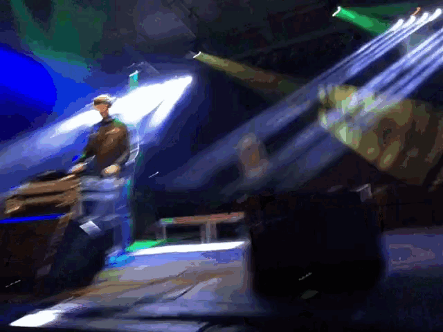 a man playing a keyboard in a dark room with a screen that says ' spongebob squarepants ' on it