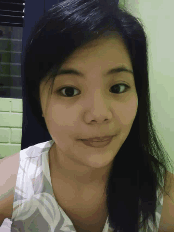 a close up of a girl 's face with a smile