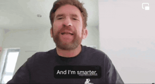 a man with a beard is wearing a shirt that says and i 'm smarter