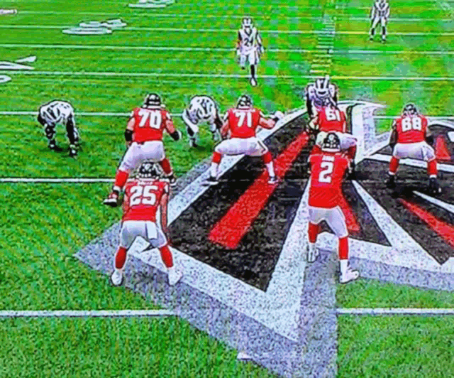 a football player with the number 25 on his jersey stands on the field