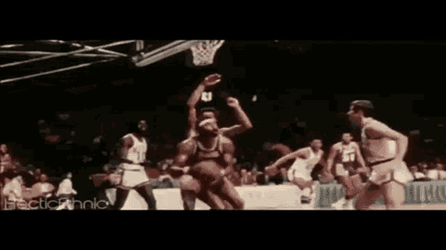 a group of basketball players are playing a game of basketball .