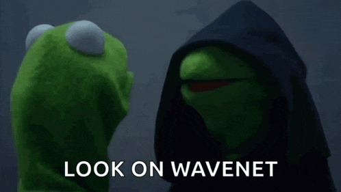 kermit the frog is wearing a black hood and talking to a puppet .