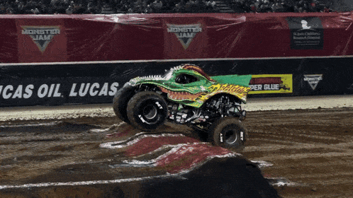 a monster jam truck jumps over a ramp