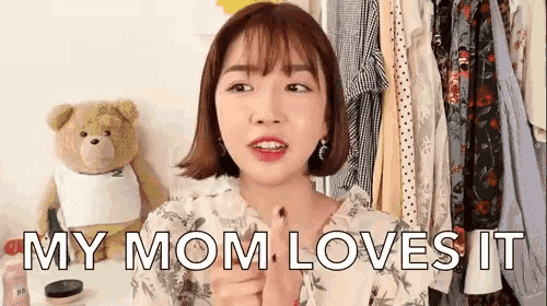 a woman says " my mom loves it " in front of a closet full of clothes