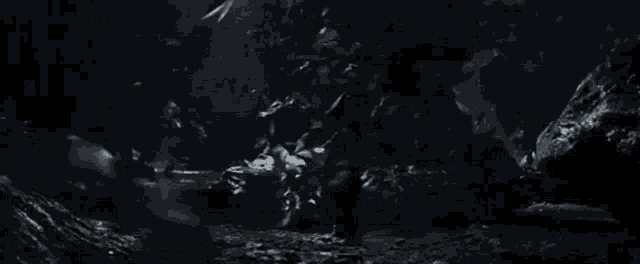 a black and white photo of a dark cave