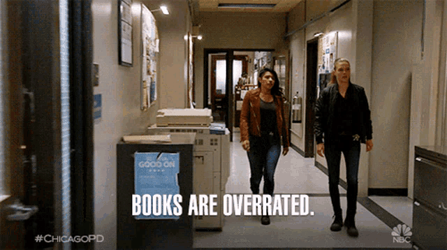 two women are walking down a hallway with the words books are overrated