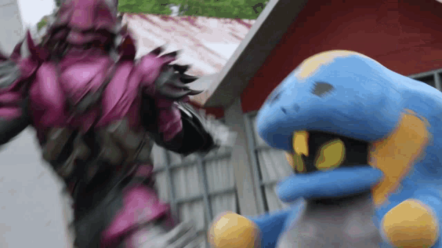 a purple monster and a blue monster are fighting
