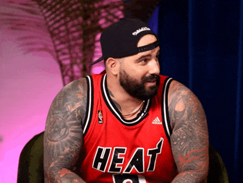 a man with a beard wears a heat jersey