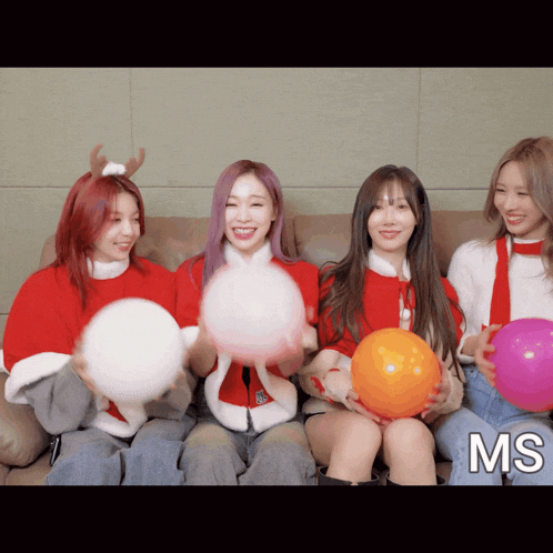 a group of girls are sitting on a couch holding balloons and the letters ms are on the bottom right