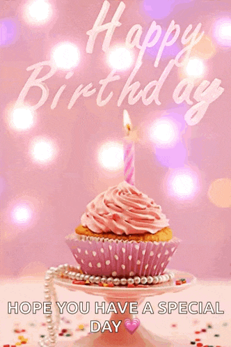 a pink cupcake with a pink frosting and a pink candle