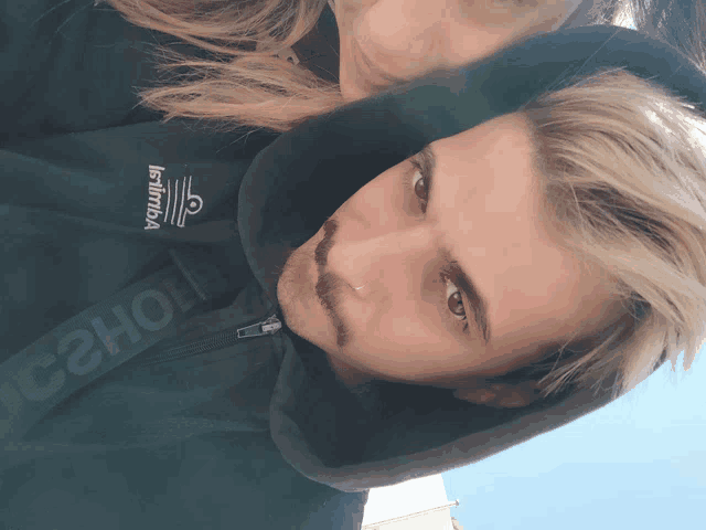 a man wearing a jacket that says infinia on it