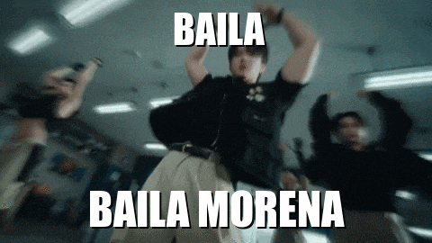 a blurry picture of a man dancing with the words baila baila morena on the bottom
