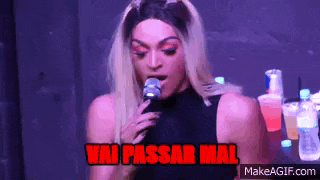 a drag queen is singing into a microphone with the words vai passar mal written above her .