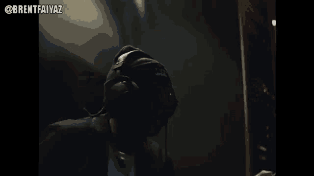 a man wearing headphones and a headset is playing a video game .