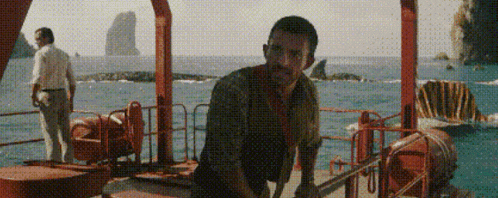 a man standing on a boat in the ocean