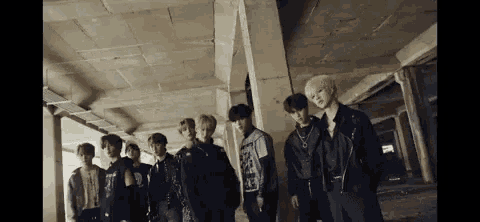 a group of young men are standing next to each other in a concrete building .