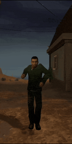 a man in a green shirt and black pants is standing in front of a building