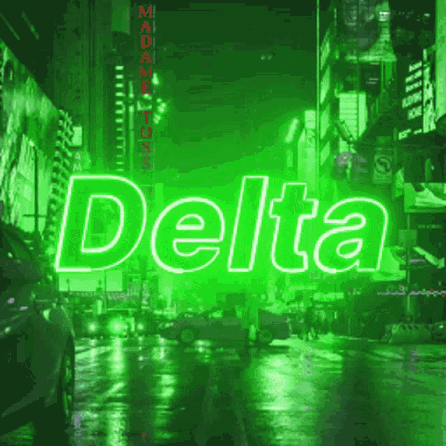 a neon sign that says delta in front of a city street