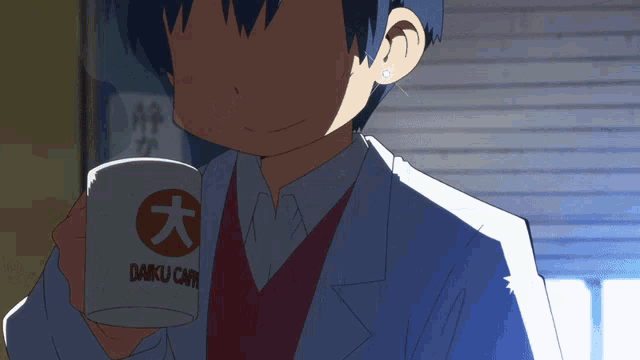 a person holding a cup that says " daku cafe "
