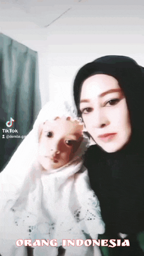 a woman and a child are posing for a photo and the caption says orang indonesia