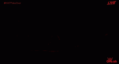 a red sign that says shinsuke nakamura on it in a dark room .