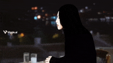 a video game character sitting at a table with a bottle of water