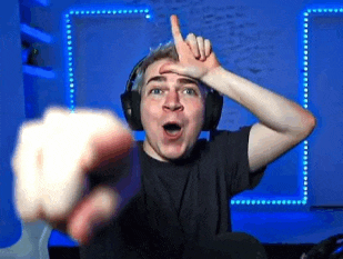 a man wearing headphones is pointing his finger at the camera .
