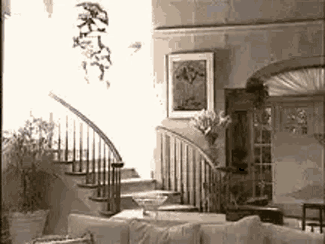 a living room with a couch and stairs leading up to the second floor .