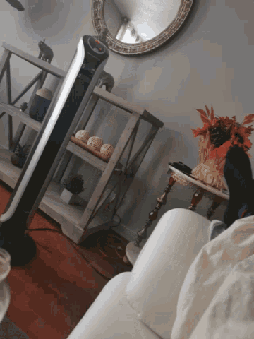 a living room with a couch and a shelf with a sign that says ' i love you ' on it