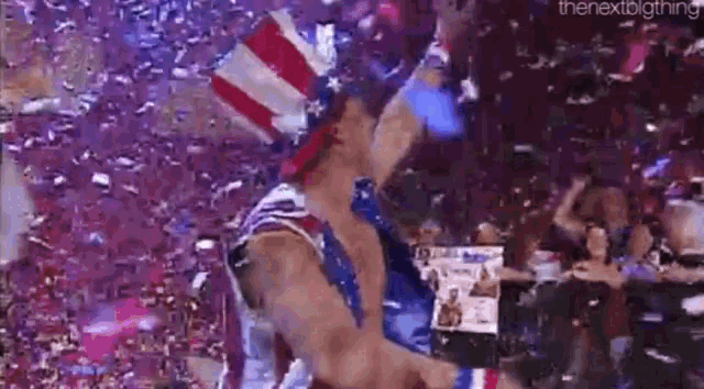 a man in a patriotic outfit is standing in front of a crowd .