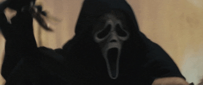 a person wearing a scream mask and a hood