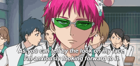 a man with pink hair and green glasses says " as you can tell by the look on my face i 'm anxiously looking forward