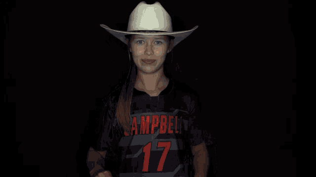 a woman wearing a cowboy hat and a campbell shirt
