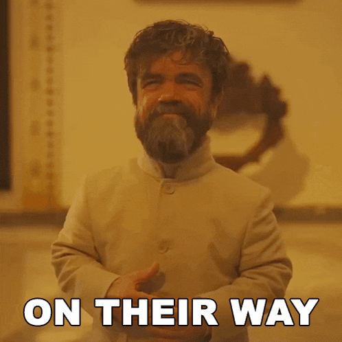 a man with a beard is standing in front of a sign that says " on their way "